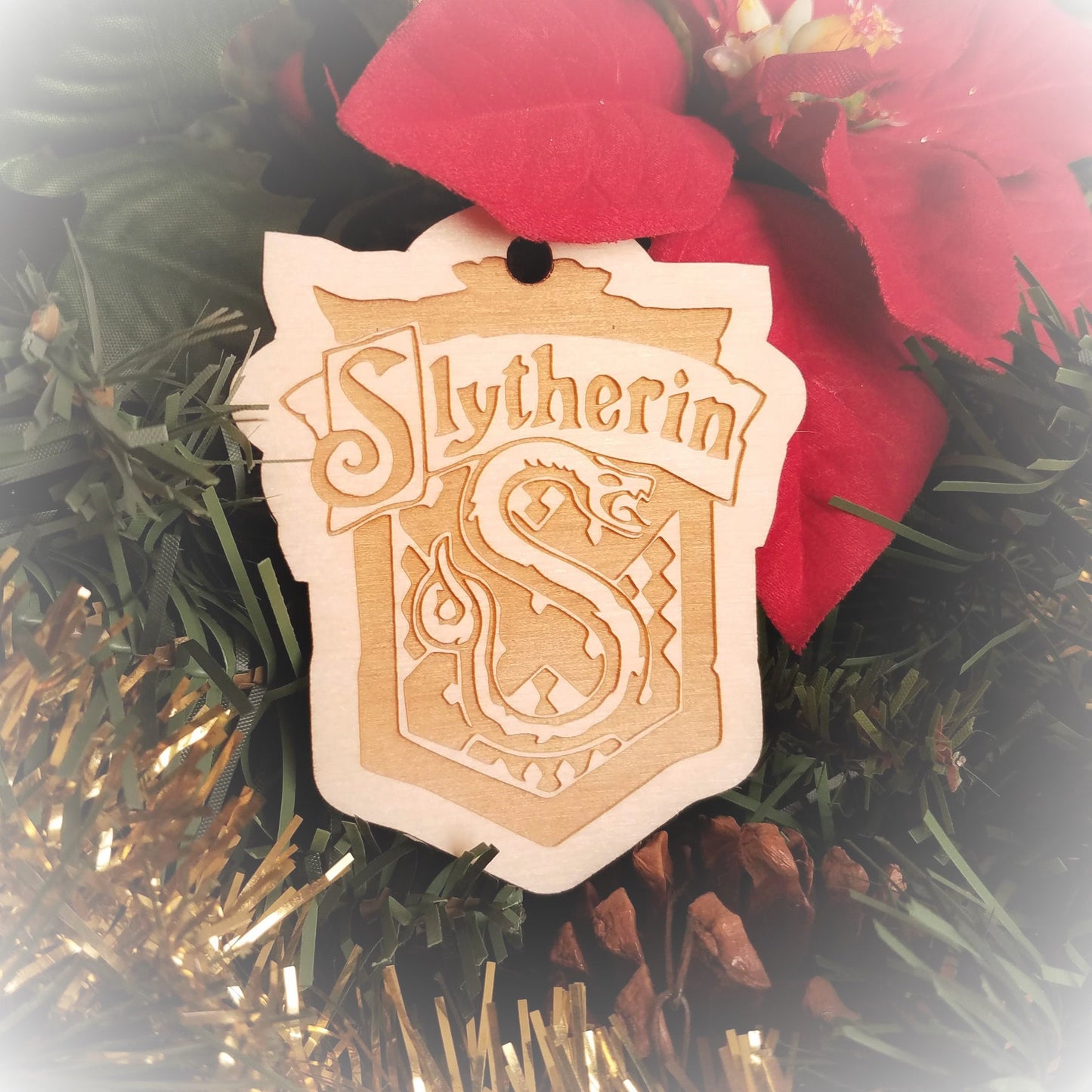 Laser engraved birch Christmas ornament with the Harry Potter Hogwarts House crest of Slytherin.